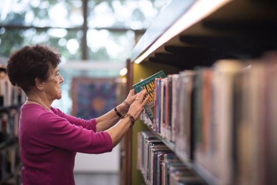 Client browsing books in the Caboolture public library.