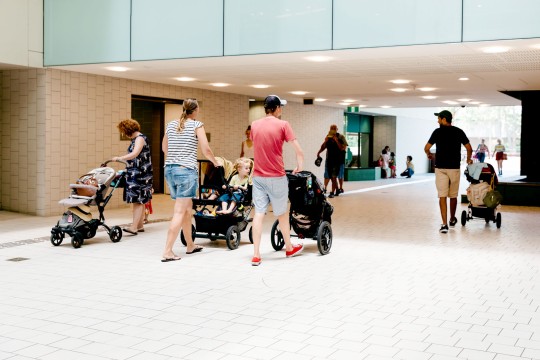 Visitors pushing prams through the Knowledge Walk at State Library