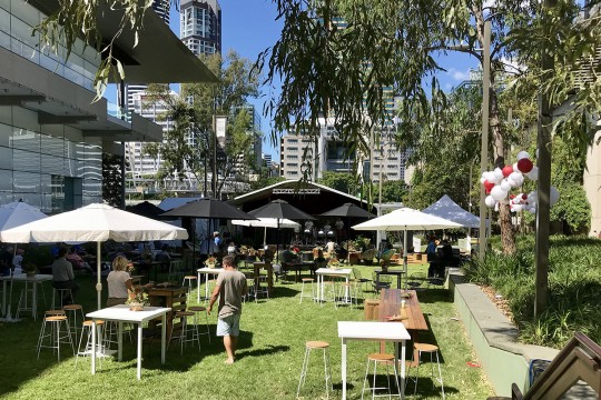 The Maiwar green set with tables and umbrellas