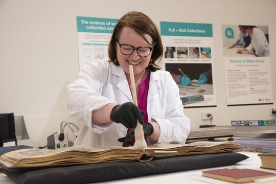 Specialist Conservator Melanie Sorenson working on a book.