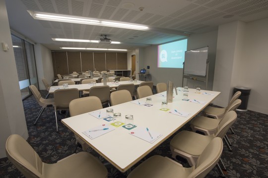 Meeting room 1B with tables whiteboard and projector