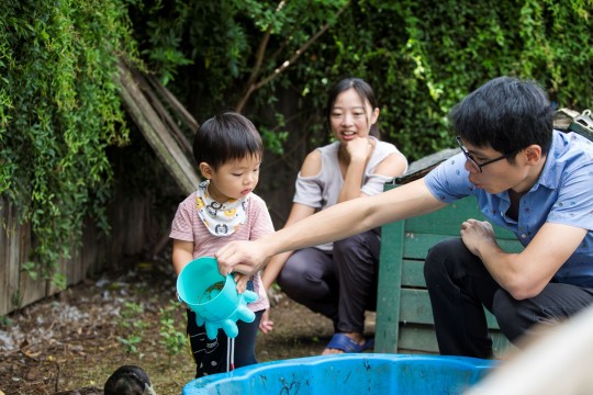 Family play with mud in pool