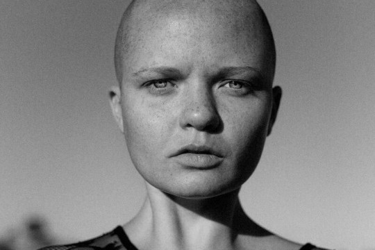 Black and white image of a woman looking directly into the camera.