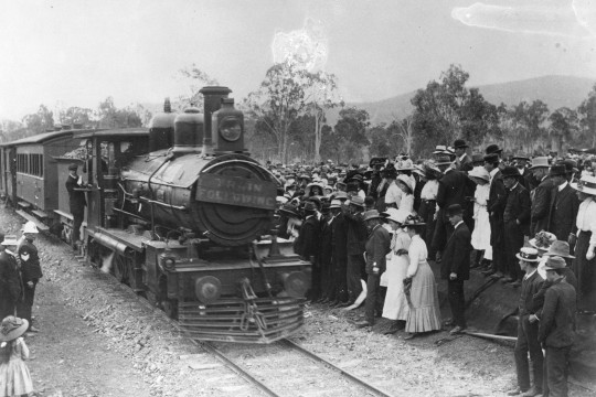 People assemble in front of the locomotive on the opening day