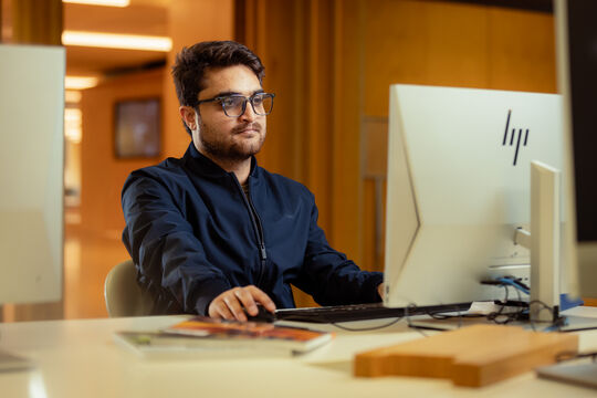 Man using a desktop computer at State Library.