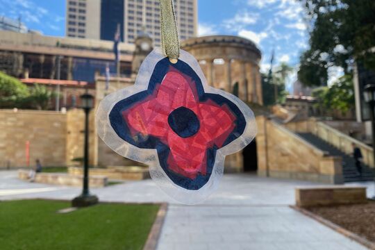 Poppy suncatcher at Anzac Square with Cenotaph in the back groundin Back