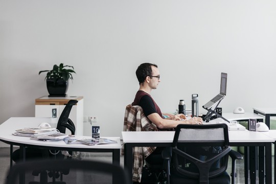 Man sitting at computer Photo By Joe Ruckli