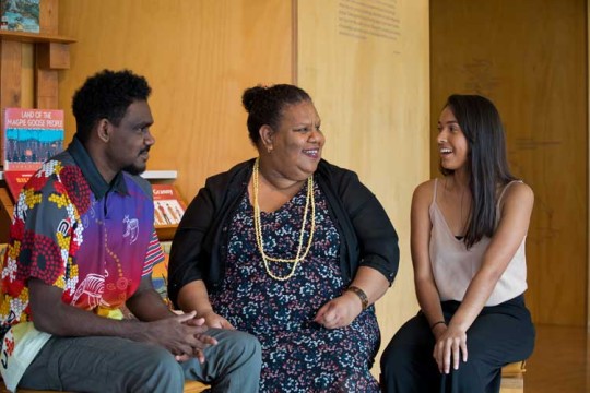 Aboriginal and Torres Islander people chatting inside the State Library of Queensland.