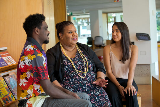 Two young people and an older woman chatting. 
