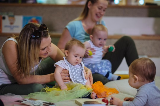 Babies and mums playing