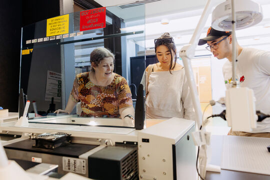 People learning to use the laser cutter