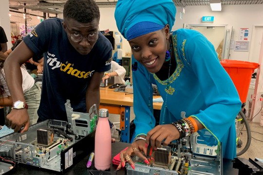 A man and a woman participating in the 2019 Siganto Digital Learning Workshops rebuilding a computer