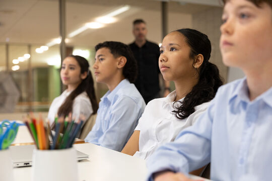 Students in classroom watching Live at the Library