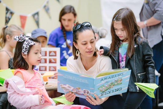 A mother reading with her two daughters at State Library Photo by Stephen Henry Photography
