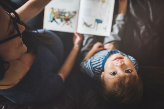 Mother and child reading together. 