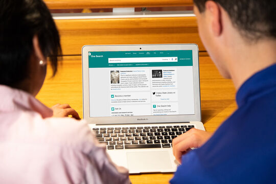 Two students using One Search catalogue