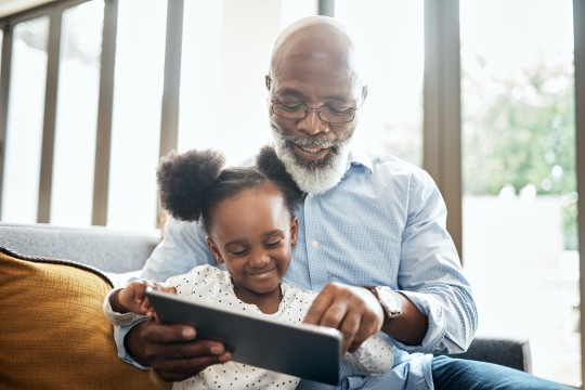 Man and child reading a book