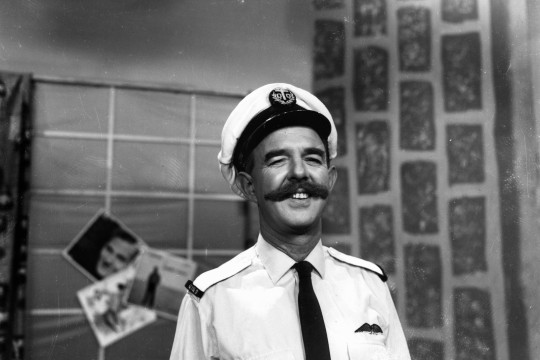 man with moustache and naval costume poses for camera 