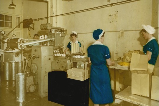 Three women working on the production line packaging ice creams at Peters Arctic Delicacy Company factory in West End Brisbane 