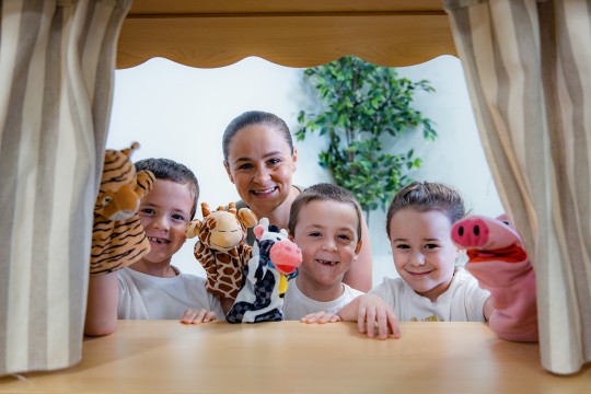 Ash Barty playing with kids and puppets