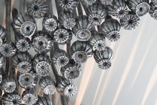 Silver metal poppy sculpture, called Black Opium by Fiona Foley