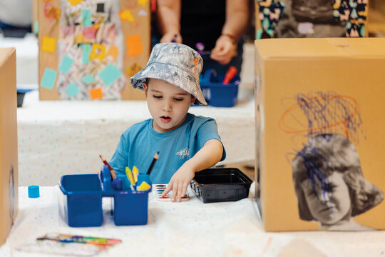 Young child finger painting.