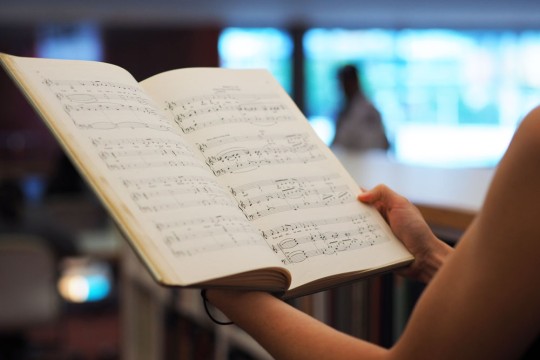 Client perusing music book at the State Library of Queensland Photo by Emma Winch