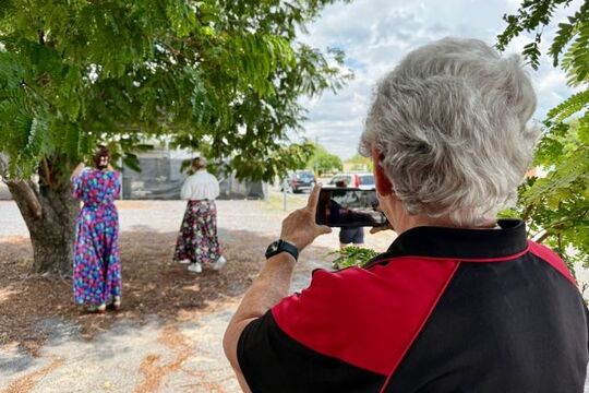 Person taking a photo of someone on their smartphone