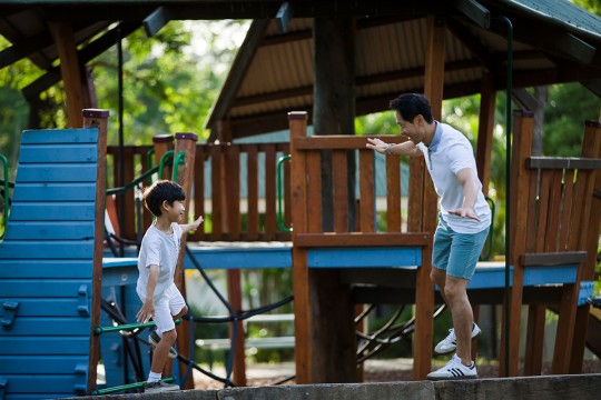 Father and son on play equipment