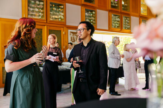 Two guests talking with each other at a Queensland Library Foundation event