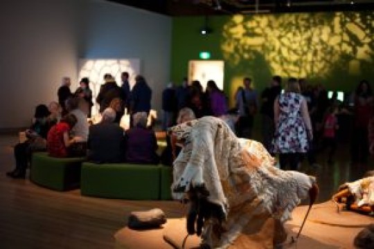 Decorated possum skin cloak on display in SLQ gallery