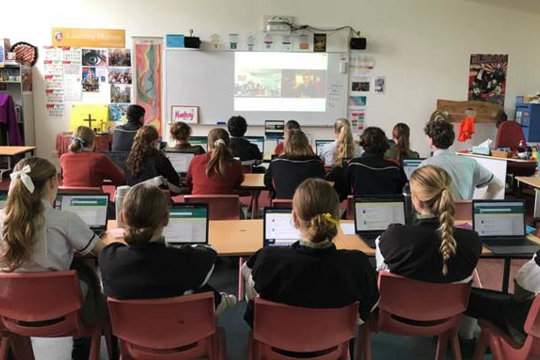 Students in classroom watching a video