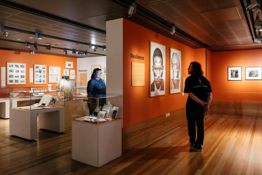 People exploring the Plantation Voices exhibition