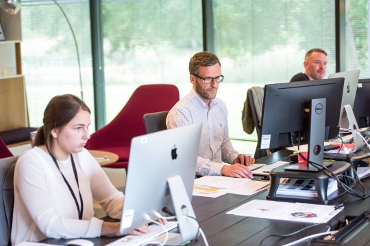 People working on computers in an office. 