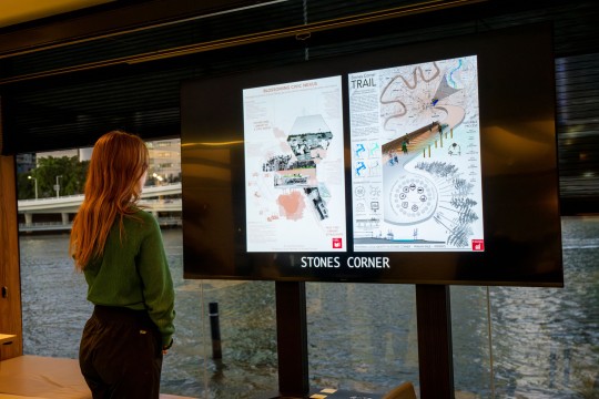 person looks at UQ digital display 