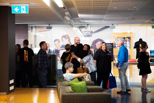 People gathering inside the I heard it on the radio showcase at the State Library.