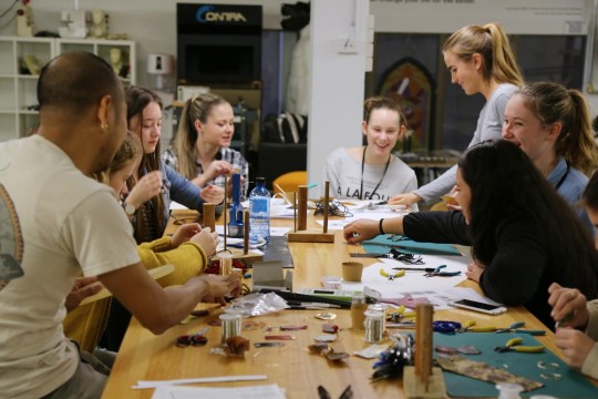 People crafting at a long table