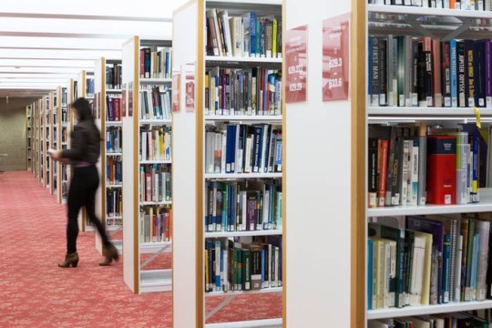 Woman in the shelves of the State Library Photo by Jeff Camden