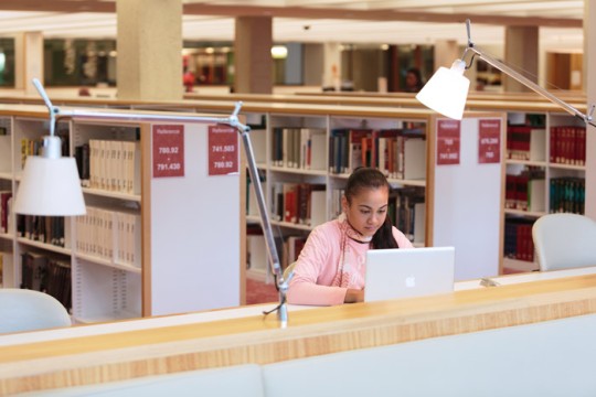 Woman using a laptop at the State Library of Queensland. Photo by Jeff Camden.