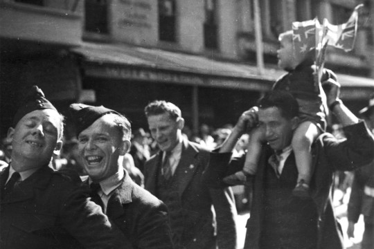 BW image of 4 soldiers participating in the VJ Day procession 1945