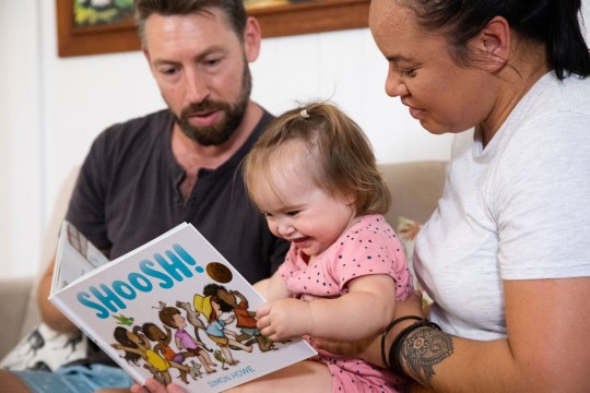Parents reading the book Shoosh with their child