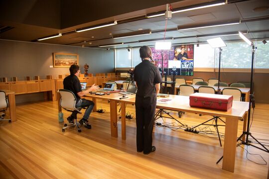 Man filming a live presentation at the library