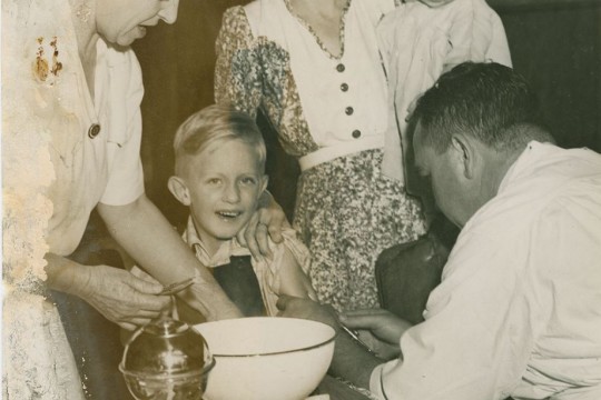 Medical Immunisation April 1949, Wendy Melloy faces up bravely while the next in line is curious, This youngster looks sceptical as the doctor from the health department injects Diphtheria serum into his arm, 1949, Brisbane Telegraph, Photographer unknown, John Oxley Library, SLQ, Negative no. 205265