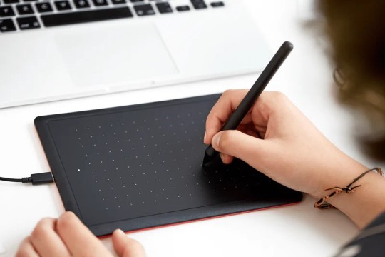Image of someone using a wacom drawing tablet