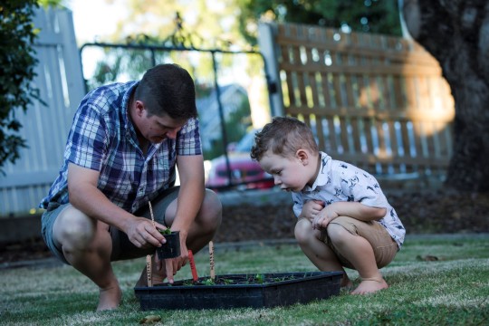 Father and son tending to garden together