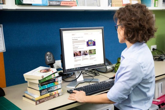 Librarian using computer at Public Library.