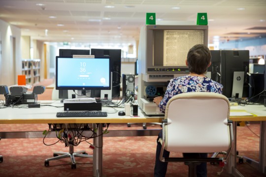 Woman sitting at computer in State Library of Queensland