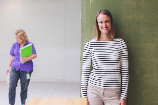 Staff member leaning against wall