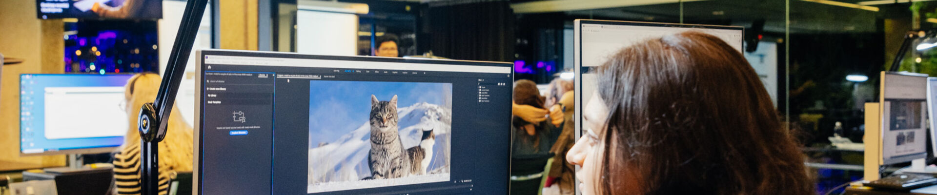 young woman uses computer to edit a video of cats