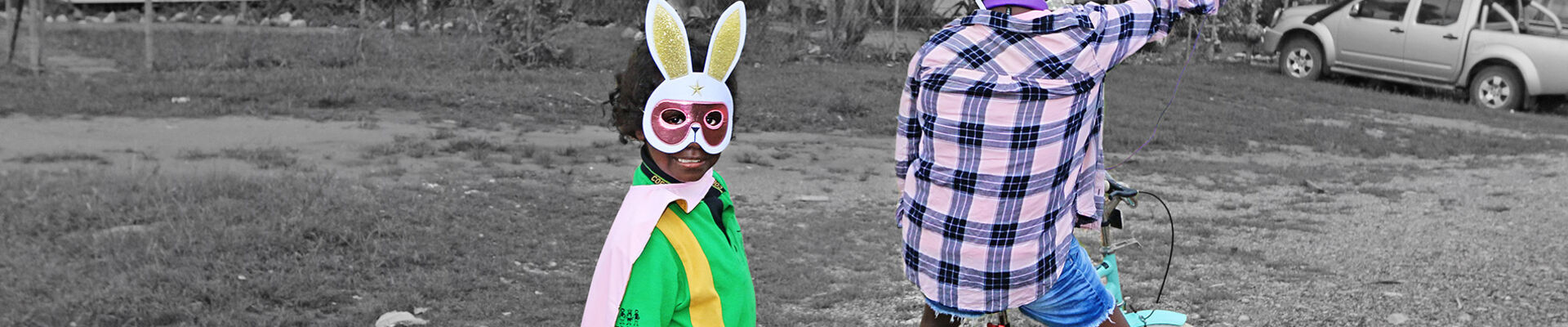 Young girl wearing a bunny mask and her mum taking a selfie outside